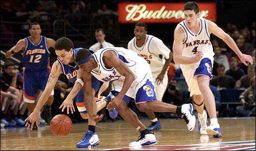 Kansas University's Aaron Miles, front, goes for a loose ball
against Florida's Anthony Roberson. The Gators beat the Jayhawks,
83-73, in the consolation game of the Preseason NIT on Friday in
New York.
