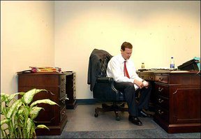 Greeted by an empty desk and blank walls, Bill Self opens a piece of mail in his new office. Self, who was hired as Kansas University's new men's basketball coach, moved Monday into Roy Williams' old office.
