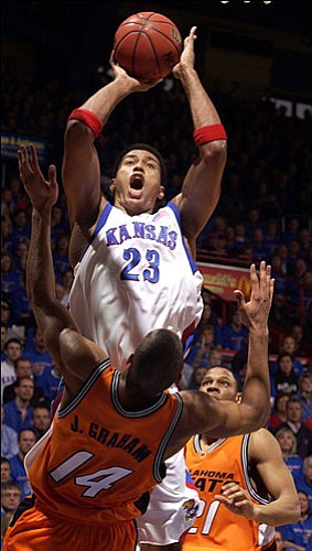 As Oklahoma State's Joey Graham (14) found out, Kansas University's
Wayne Simien (23) could be a force inside. Against the Cowboys on
Feb. 27, Simien collected 32 points and 12 rebounds in KU's 81-79
victory.
