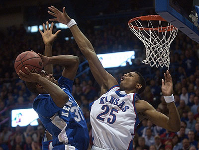 Kansas University freshman guard Brandon Rush, right, rises to
block the shot of Kentucky's Joe Crawford during the first half of
the Jayhawks' lopsided 73-46 rout of the Wildcats. Rush had 24
points, 12 rebounds, four assists, two blocks and a steal in the
victory Saturday in Allen Fieldhouse.
