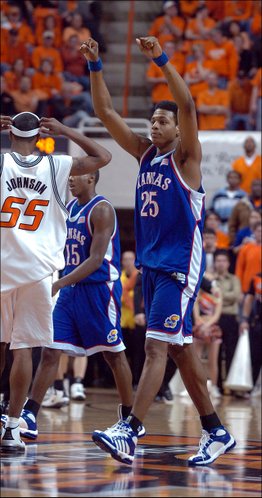 
Walking off the court during a timeout Kansas guard Brandon Rush throws his fists in the air before the Cowboy fans as the Jayhawks begin to run away with the game, Monday night at Gallagher-Iba Arena.