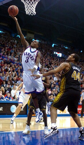 Kansas guard Russell Robinson drives in to the bucket against Missouri defender Kalen Grimes in the second half.
