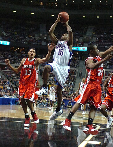 Kansas guard Mario Chalmers drives to the bucket against the Bradley defense in the second half.