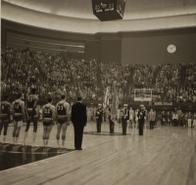 Kansas University players, from left, Maurice King, Gene Elstun, Wilt Chamberlain, John Parker and Ron Loneski stand at attention during the playing of the National Anthem prior to the NCAA National Championship game. The game was played in Municipal Auditorium in Kansas City, Mo., on March 23, 1957. 