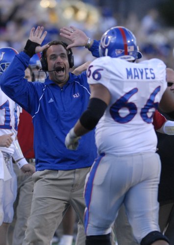Kansas offensive line coach John Reagan looks to high five lineman Adrian Mayes following a Jake Sharp touchdown during the second half against the Buffaloes, Saturday, Oct. 20, 2007 at Folsom Field in Boulder.