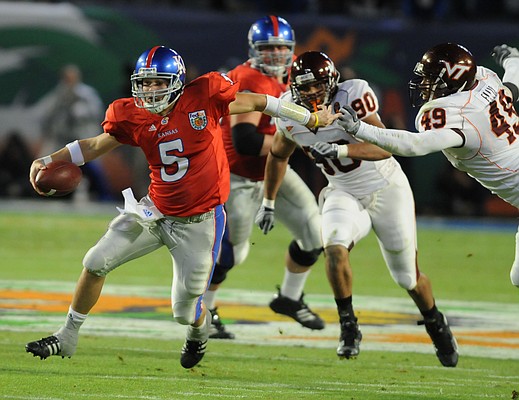 Kansas quarterback Todd Reesing scampers upfield past Virginia Tech defensive end Chris Ellis.