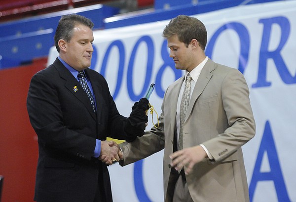 Kansas University Football Offensive Coordinator Ed Warinner, left, presents quarterback Todd Reesing with the 2007 John Hadl Offensive MVP Award on Saturday at Allen Fieldhouse.  KU celebrated their Orange Bowl victory and 12-1 record with fans at the Football Awards Banquet.