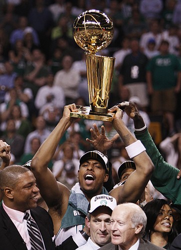 Boston's Paul Pierce hoists the Larry O'Brien Trophy. The Celtics crushed the Lakers in Game 6 of the NBA Finals on Tuesday in Boston, and Pierce was named MVP after the game. Pierce played at Kansas University from 1995 to 1998.