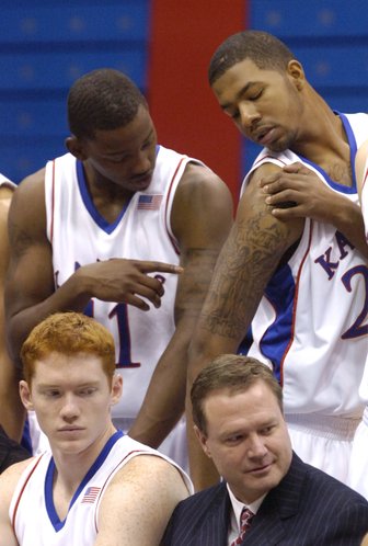 Freshmen Quintrell Thomas, left, and Markieff Morris compare tattoos Thursday during the KU media day at Allen Fieldhouse.