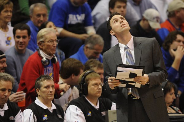 Former Jayhawk guard and director of basketball operations Brett Ballard checks the scoreboard during a timeout in this Dec. 20, 2008 file photo from Allen Fieldhouse.