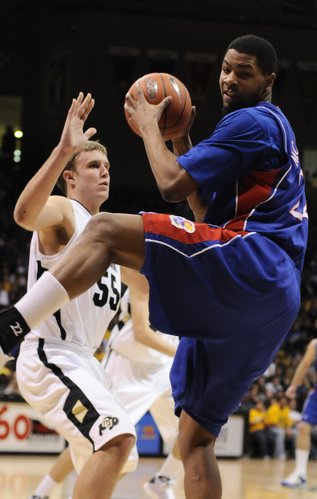 Kansas forward Marcus Morris spins away from Colorado forward Trey Eckloff with an offensive rebound during the second half Saturday, Jan. 17, 2009 at the Coors Events Center in Boulder, Colorado.