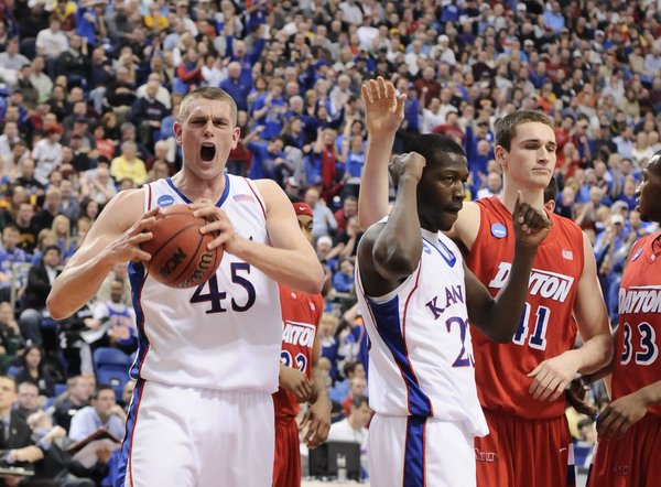 Kansas center Cole Aldrich screams in jubilation after getting a bucket and a foul Dayton during the first half Sunday March 22, 2009 at the Metrodome in Minneapolis. At right is Kansas forward Mario Little, Dayton center Kurt Huelsman and Dayton forward Chris Wright.