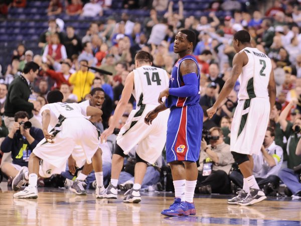 Kansas guard Sherron Collins looks back to the Kansas bench after fouling Michigan State guard Kalen Lucas on a made bucket late in the second half Friday, March 27, 2009 at Lucas Oil Stadium in Indianapolis.