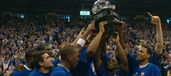 Kansas University basketball players hoist their newly-earned Big 12 regular season title trophy. The Jayhawks defeated Texas in March 2007 to take the regular season title outright and notch the program's 1,900th victory.