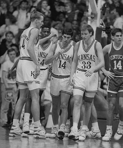 KU players gather on the court during KU's 150-95 blowout of Rick Pitino's Kentucky Wildcats in December, 1989. From left are Pekka Markkanen, Freeman West, Kevin Prichard and Jeff Gueldner. Seven KU players scored in double figures.