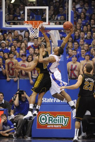 Kansas forward Marcus Morris goes up for a dunk over Missouri's Keith Ramsey Monday, Jan. 25, 2010 at Allen Fieldhouse.