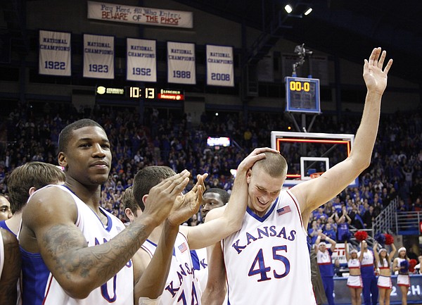 Kansas center Cole Aldrich waves to the Allen Fieldhouse crowd after he was announced the NCAA Basketball Academic All-American of the Year Monday, Feb. 22, 2010.