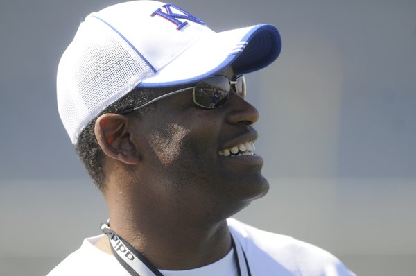 Kansas head coach Turner Gill watches his players warm up at the start of practice Wednesday.