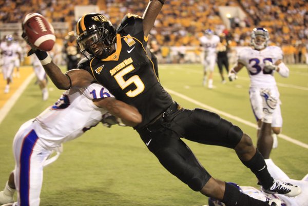 Southern Miss receiver DeAndre Brown extends toward the goal line as he is hit by Kansas cornerback Chris Harris during the third quarter, Friday, Sept. 17, 2010 at M.M. Roberts Stadium in Hattiesburg, Mississippi.