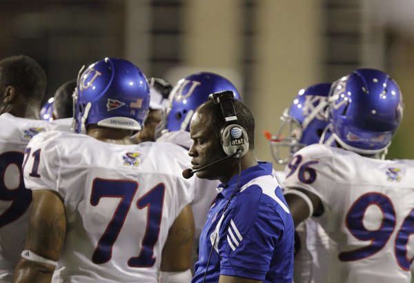 Kansas head coach Turner Gill closes his eyes as he paces past his players during the fourth quarter against Southern Miss, Friday, Sept. 17, 2010 at M.M. Roberts Stadium in Hattiesburg, Mississippi. The Jayhawks fell to the Golden Eagles 31-16.