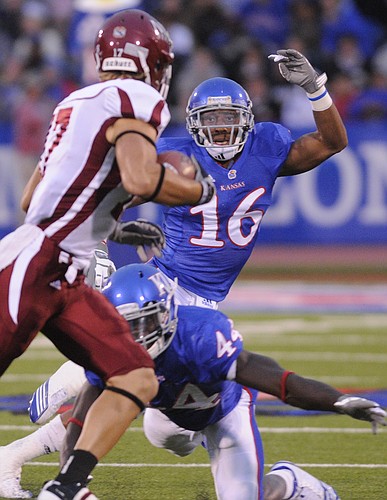 Kansas defenders Chris Harris (16) and Olaitan Oguntodu (44) collapse on New Mexico State tight end Kyle Nelson (17) during the first quarter Friday, Sept. 25, 2010 at Kivisto Field.