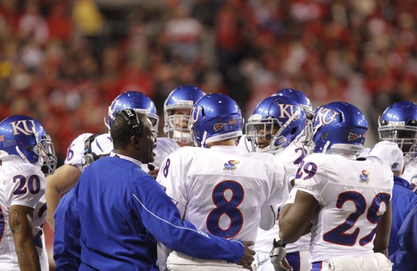 Kansas head coach Turner Gill gathers his offense during a timeout against Nebraska during the third quarter, Saturday, Nov. 13, 2010 at Memorial Stadium in Lincoln.