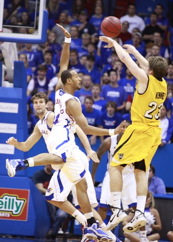 Kansas guard Travis Releford jumps in to defend against a shot by Valparaiso guard Matt Kenney during the second half, Monday, Nov. 15, 2010 at Allen Fieldhouse. Also pictured is Kansas center Jeff Withey.