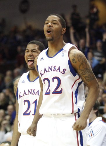 Kansas forwards Markieff Morris (21) and Marcus Morris (22) react to a dunk by teammate Elijah Johnson during the second half against Ohio, Friday, Nov. 26, 2010 at the Orleans Arena.