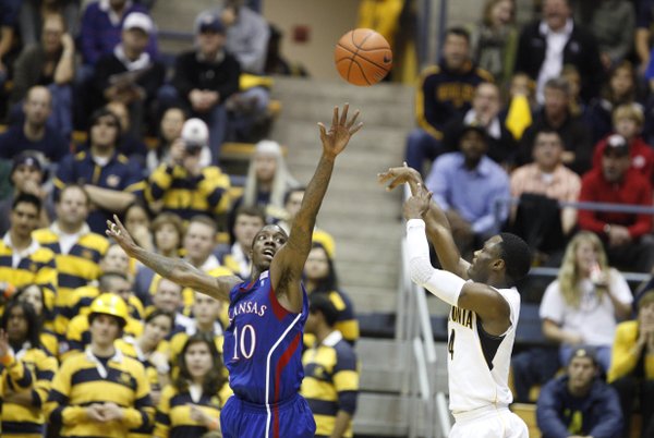 Kansas guard Tyshawn Taylor extends to defend against a shot by Cal guard Gary Franklin during the first half, Wednesday, Dec. 22, 2010 at Haas Pavilion in Berkeley, California.