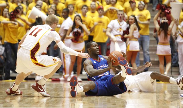 Kansas forward Mario Little looks for an outlet from the floor as he is pressured by Iowa State guard Scott Christopherson during the second half on Wednesday, Jan. 12, 2011 at Hilton Coliseum in Ames, Iowa.
