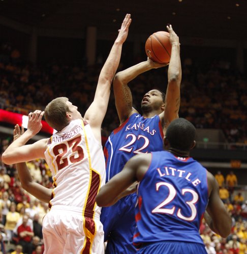 Kansas forward Marcus Morris turns for a shot over Iowa State forward Jamie Vanderbeken during the second half on Wednesday, Jan. 12, 2011 at Hilton Coliseum in Ames, Iowa. In front is Kansas forward Mario Little.