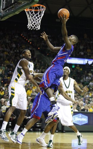 Kansas guard Josh Selby swoops in for a bucket over Baylor defenders Perry Jones, left, and Anthony Jones during the first half on Monday, Jan. 17, 2011 at the Ferrell Center in Waco, Texas.