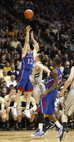 Kansas guard Brady Morningstar shoots a three over Colorado guard Levi Knutson during the first half on Tuesday, Jan. 25, 2011 at the Coors Events Center in Boulder.