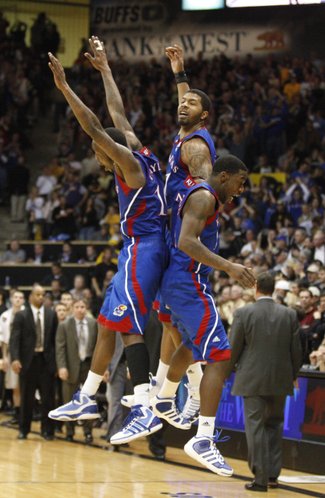 Kansas players Tyshawn Taylor, left, Markieff Morris, center, and Elijah Johnson come together for a flying, celebratory bump following the Jayhawks' 82-78 win over Colorado on Tuesday, Jan. 25, 2011 at the Coors Events Center in Boulder.