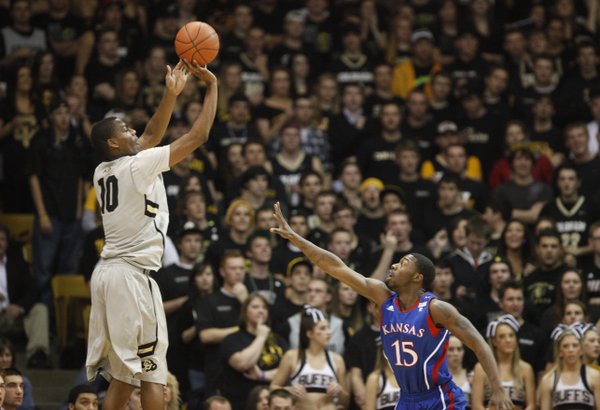Colorado guard Alec Burks pulls up for a three-pointer over Kansas guard Elijah Johnson during the first half on Tuesday, Jan. 25, 2011 at the Coors Events Center in Boulder.
