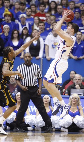 Kansas guard Tyrel Reed pulls up for a shot over Missouri guard Marcus Denmon during the first half on Monday, Feb. 7, 2011 at Allen Fieldhouse.
