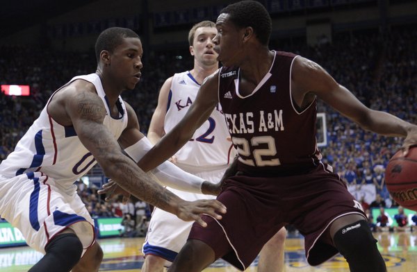 Thomas Robinson (0) and Brady Morningstar (12) double-team Texas A&M's Khris Middleton (22) Wednesday, March 2, 2011.
