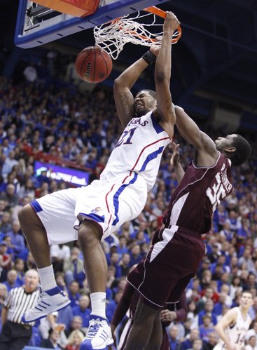 Kansas forward Markieff Morris delivers a dunk before Texas A&M forward Ray Turner during the second half on Wednesday, March 2, 2011 at Allen Fieldhouse.
