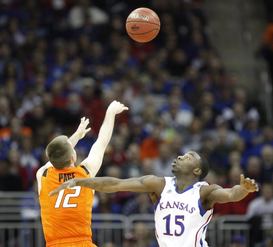 Kansas guard Elijah Johnson watches as Oklahoma State guard Keiton Page puts up a three during the second half on Thursday, March 10, 2011 at the Sprint Center in Kansas City.