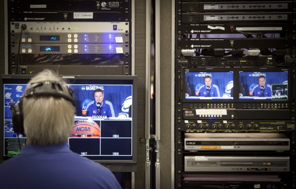 Kansas head coach Bill Self is seen on the video monitors of production equipment during a press conference on Saturday, March 26, 2011 at the Alamodome in San Antonio.