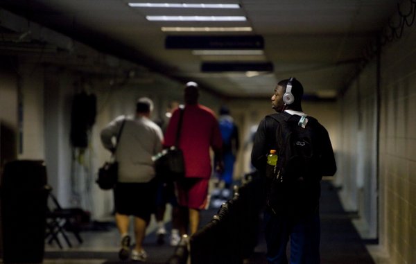 Kansas guard Elijah Johnson listens to his headphones as he and the team leave the Alamodome following a round of interviews and press conferences on Saturday, March 26, 2011 at the Alamodome in San Antonio.