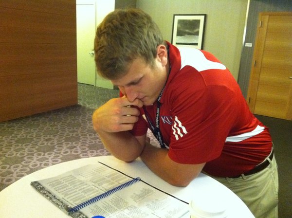 Kansas tight end Tim Biere reads over the KU media guide on Tuesday morning at Big 12 Media Days at the Westin Galleria in Dallas.