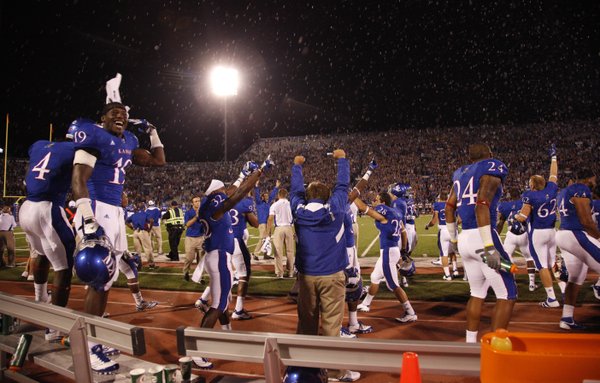Water flies along the Kansas sideline after officials confirmed a touchdown by KU receiver D.J. Beshears to put the KU ahead of Northern Illinois late in the fourth quarter on Saturday, Sept. 10, 2011 at Kivisto Field. The Jayhawks won, 45-42.