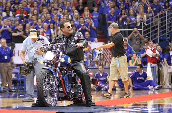 Kansas head coach Bill Self rides out onto James Naismith court on a custom-made motorcycle with imagery from the 2008 National Championship during Late Night in the Phog on Friday, Oct. 14, 2011 at Allen Fieldhouse.