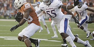 Kansas special teams player Michael Reynolds looks to wrap up Texas returner Malcolm Brown on the opening kickoff Saturday, Oct. 29, 2011 at Darrell K Royal-Texas Memorial Stadium.