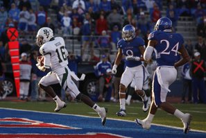 Baylor receiver Tevin Reese slips in for a touchdown past Kansas defenders Keeston Terry (9) and Bradley McDougald (24) during overtime on Saturday, Nov. 12, 2011 at Kivisto Field.