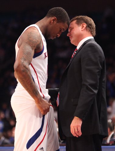 Kansas head coach Bill Self talks with forward Thomas Robinson after Robinson fouled out of the game against Kentucky during the second half on Tuesday, Nov. 15, 2011 at Madison Square Garden in New York.