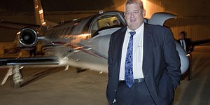 Charlie Weis, formerly the offensive coordinator at Florida, gets off the Kansas University plane at the Lawrence Airport on Thursday night around 8:30 p.m. Weis has agreed to become the 37th football coach in KU history. KU will hold a press conference to introduce Weis on Friday.