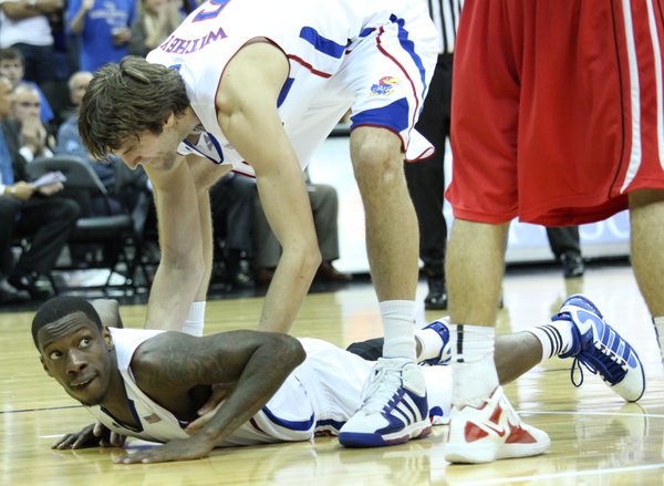 Kansas center Jeff Withey helps up teammate Tyshawn Taylor after Taylor was fouled in second half against Davidson on Monday, Dec. 19, 2011 at Sprint Center in Kansas City, Mo.