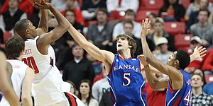 Kansas center Jeff Withey defends a shot by Texas Tech forward Jaye Crockett during the first half Wednesday, Jan. 11, 2012, at United Spirit Arena.
